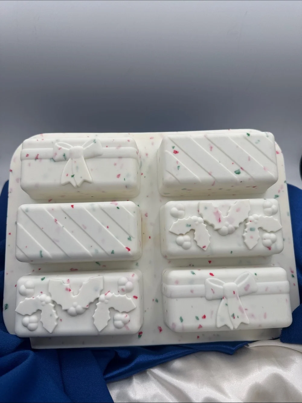 This image shows a holiday-themed silicone snap bar mold being used to create fe